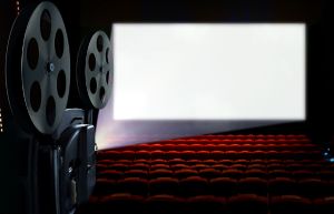 Projector in cinema hall with blank white screen