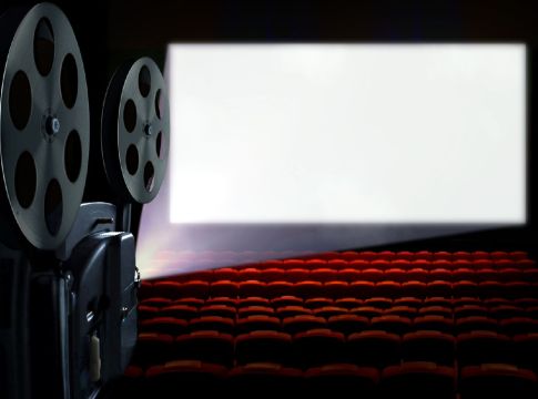 Projector in cinema hall with blank white screen
