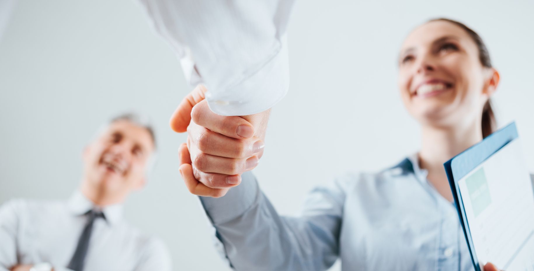 Confident business people shaking hands and woman smiling, recruitment and agreement concept