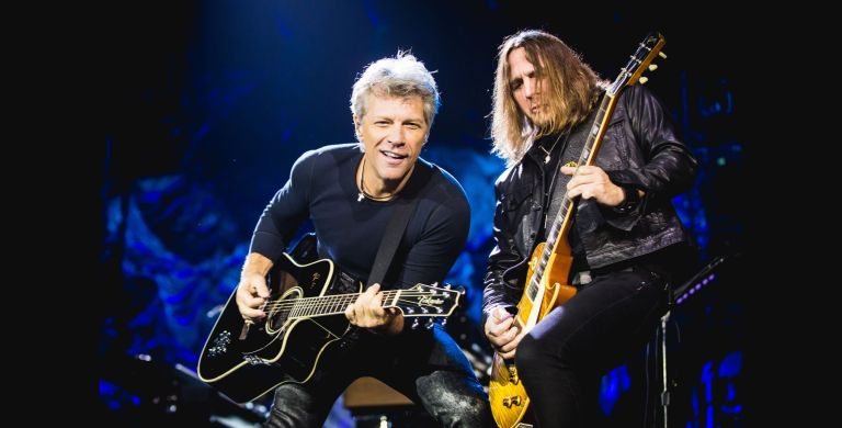 Jon Bon Jovi of American rock band Bon Jovi, left, performs during their concert