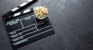 Cinema concept with movie theatre elements set of clapper board and salty popcorn