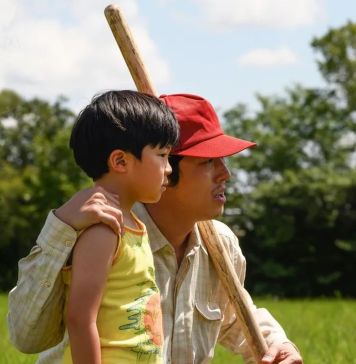 απο την ταινία Minari (2020) πατέρας και γιος σε γρασιδι στην εξοχη