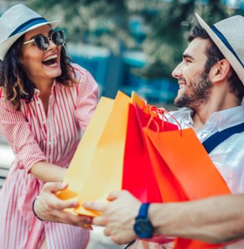 Couple having fun outdoor while doing shopping together