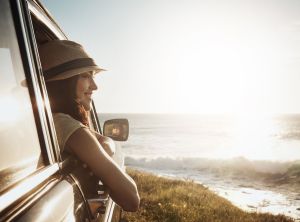 Live higher than the sky and deeper than the ocean. a young woman enjoying a road trip along the coast