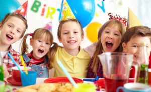 Group of adorable kids having fun at birthday party