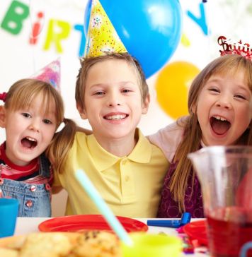 Group of adorable kids having fun at birthday party